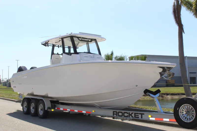 Slide: The Image of 2024 Fountain 32 NX boat on a Rocket trailer, parked outdoors. - 11