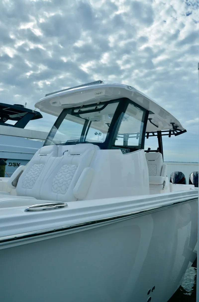 Slide: The Image of 2024 Fountain 32 NX boat with sleek design under a cloudy sky. - 17
