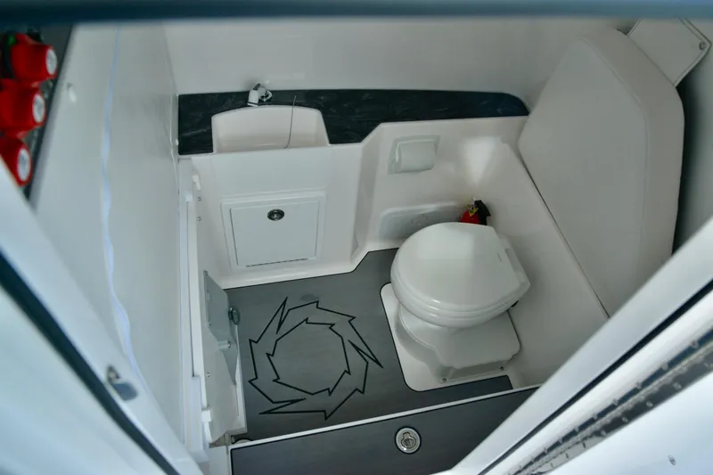 Slide: The Image of 2024 Fountain 32 NX boat interior bathroom with toilet and storage. - 21