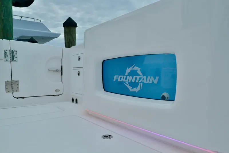 Slide: The Image of 2024 Fountain 32 NX boat interior with logo and storage compartments. - 23