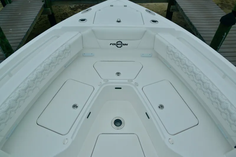 Slide: The Image of 2024 Fountain 32 NX boat bow with storage compartments and seating. - 25