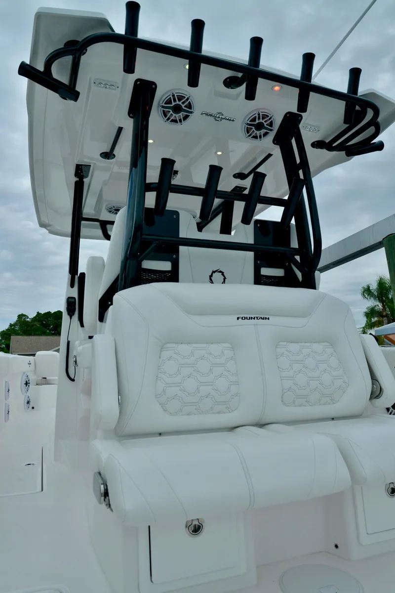 Slide: The Image of 2024 Fountain 32 NX boat with white seating and black rod holders. - 31