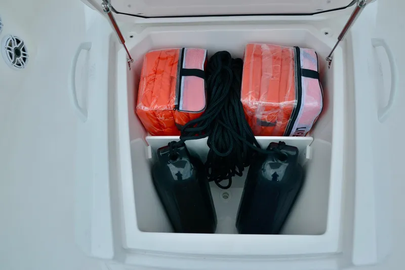 Slide: The Image of Storage compartment of 2024 Fountain 32 NX boat with life vests and fenders. - 32
