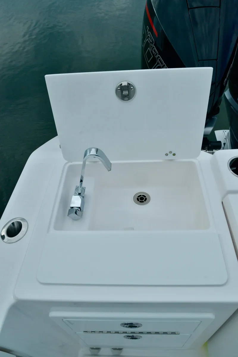 Slide: The Image of Fountain 32 NX 2024 boat sink and faucet setup. - 33