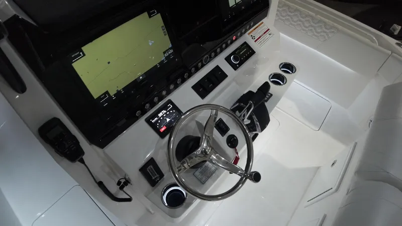 Slide: The Image of 2024 Fountain 32 NX boat cockpit with steering wheel and navigation screens. - 36