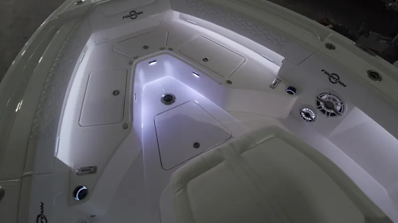 Slide: The Image of 2024 Fountain 32 NX boat interior with LED lighting and storage compartments. - 37