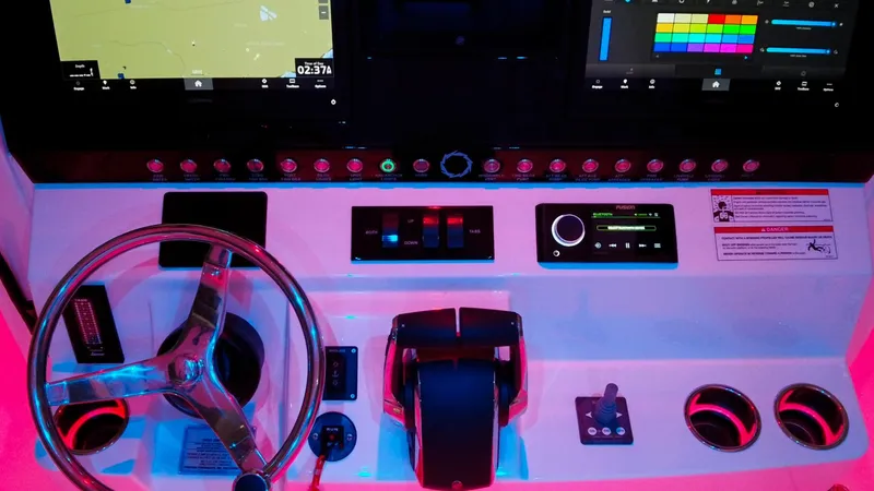 Slide: The Image of 2024 Fountain 32 NX boat dashboard with steering wheel, controls, and digital displays. - 42