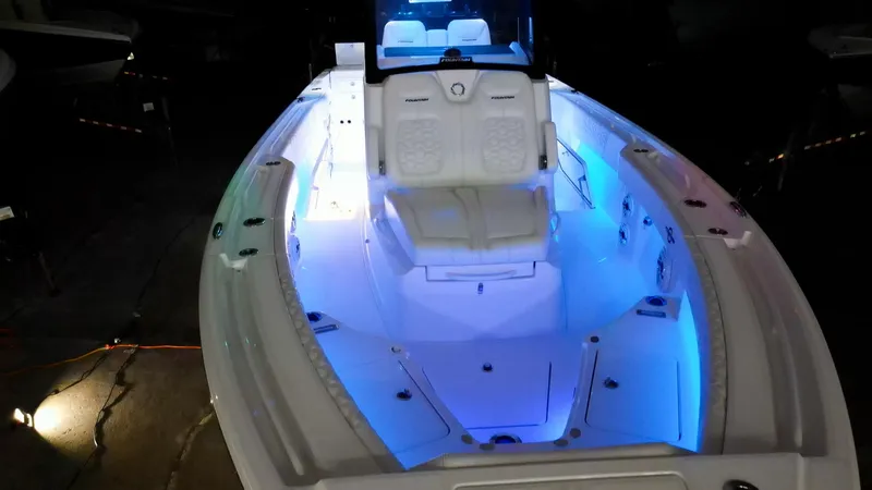 Slide: The Image of 2024 Fountain 32 NX boat with illuminated deck and seating area. - 45