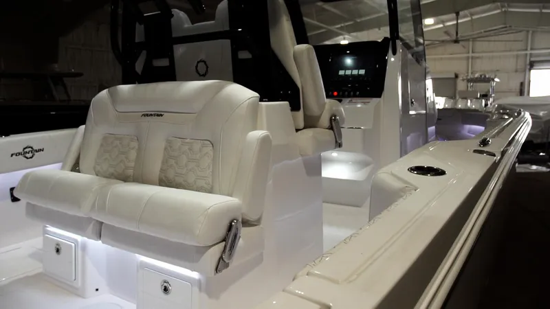 Slide: The Image of 2024 Fountain 32 NX boat interior with white leather seats and modern dashboard. - 49
