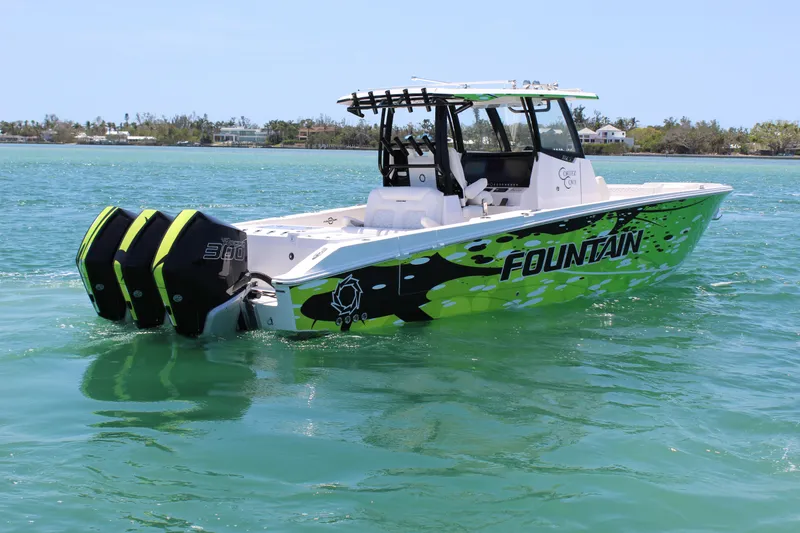 Slide: The Image of 2024 Fountain 32 NX boat with vibrant green design on clear water. - 5