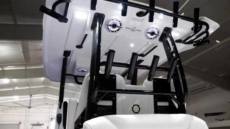 Slide: The Image of 2024 Fountain 32 NX boat interior with rod holders and speakers. - 50