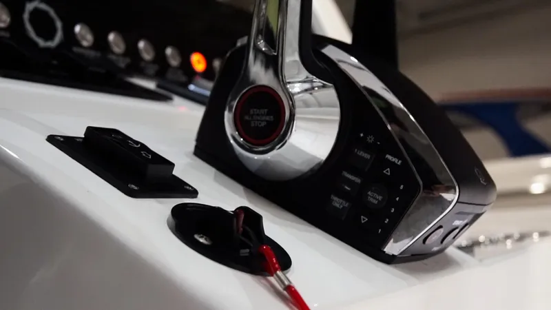 Slide: The Image of Close-up of 2024 Fountain 32 NX boat control panel and throttle. - 53