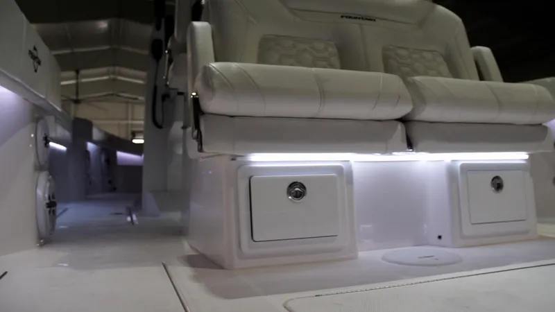 Slide: The Image of 2024 Fountain 32 NX boat interior with illuminated seating and storage compartments. - 56