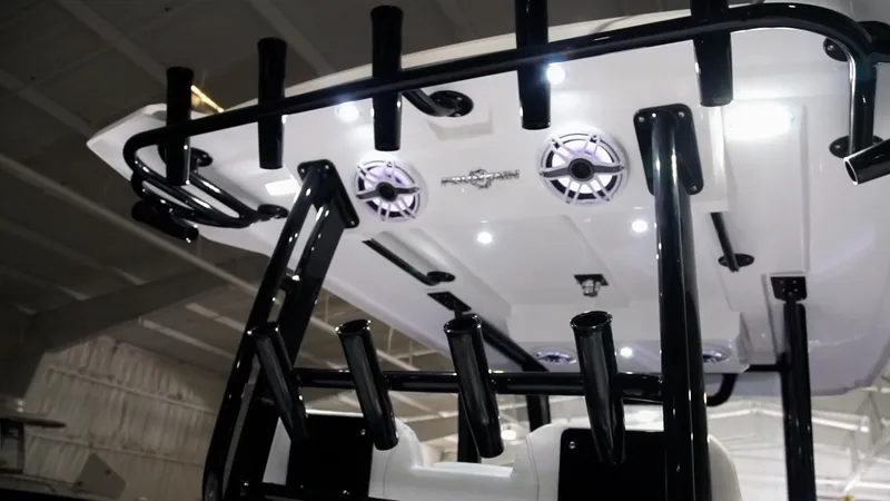 Slide: The Image of 2024 Fountain 32 NX boat interior with rod holders and speakers. - 57
