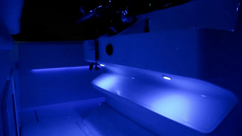 Slide: The Image of 2024 Fountain 32 NX boat interior with blue LED lighting. - 60