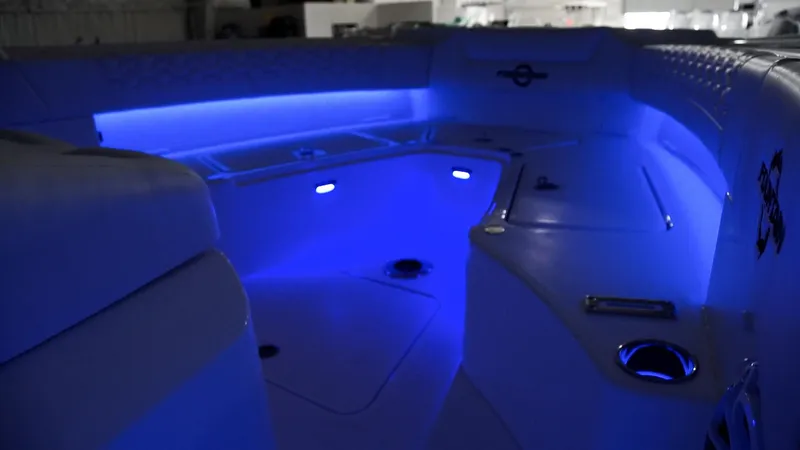Slide: The Image of 2024 Fountain 32 NX boat interior with blue LED lighting. - 61