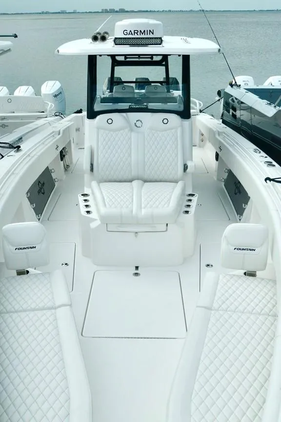 Slide: The Image of 2024 Fountain Bluewater 38 Tournament Edition boat with white seating and Garmin electronics. - 18