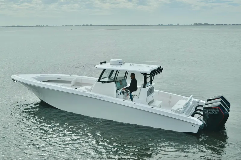 Slide: The Image of 2024 Fountain Bluewater 38 Tournament Edition boat on calm water. - 2