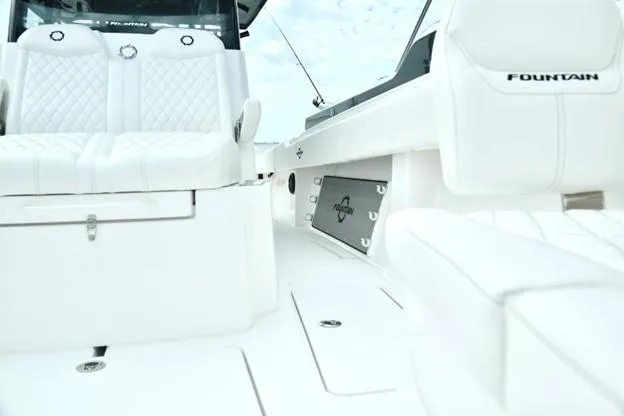 Slide: The Image of 2024 Fountain Bluewater 38 Tournament Edition boat interior with white seating. - 5