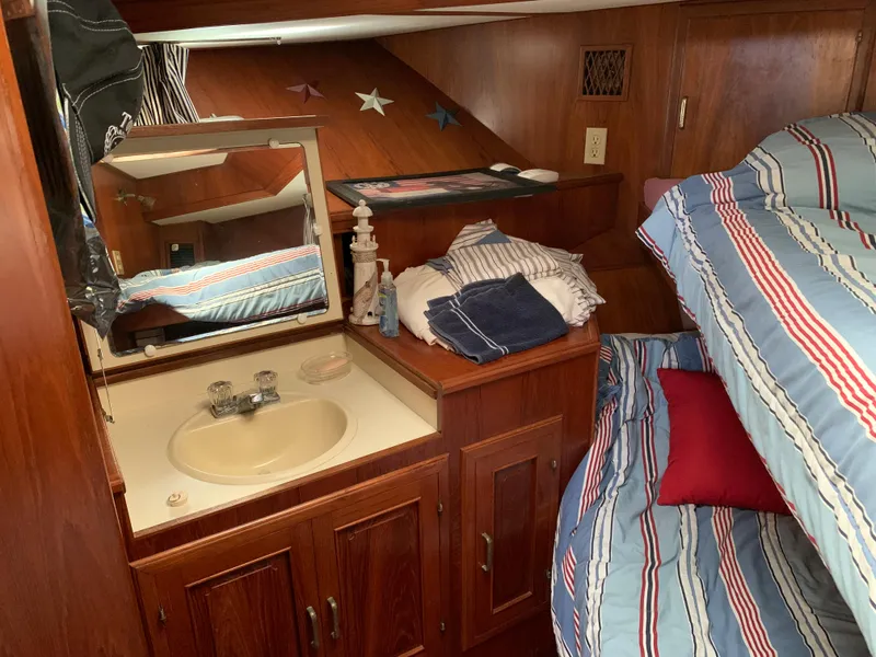 Slide: The Image of Cozy cabin interior of 1987 Kha Shing Vista 40 with sink, mirror, and bunk beds. - 13