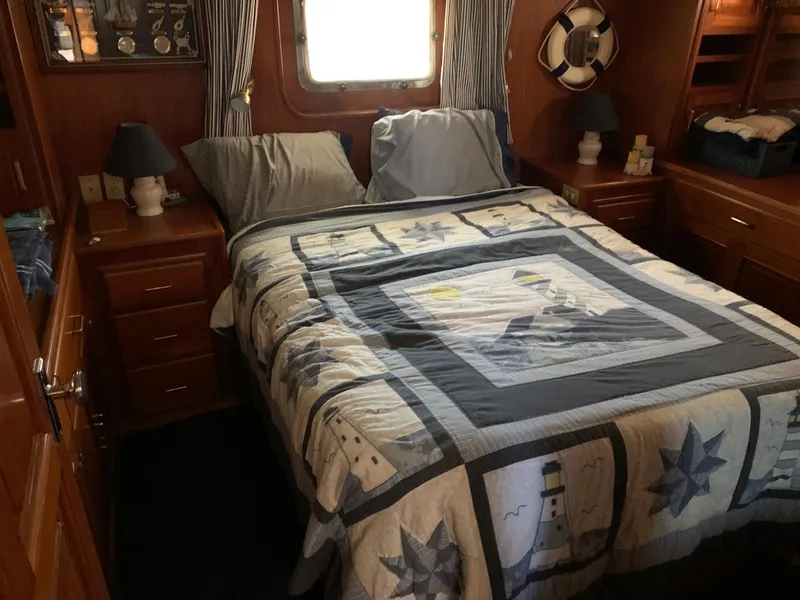 Slide: The Image of Cozy bedroom in 1987 Kha Shing Vista 40 yacht with nautical-themed decor. - 15