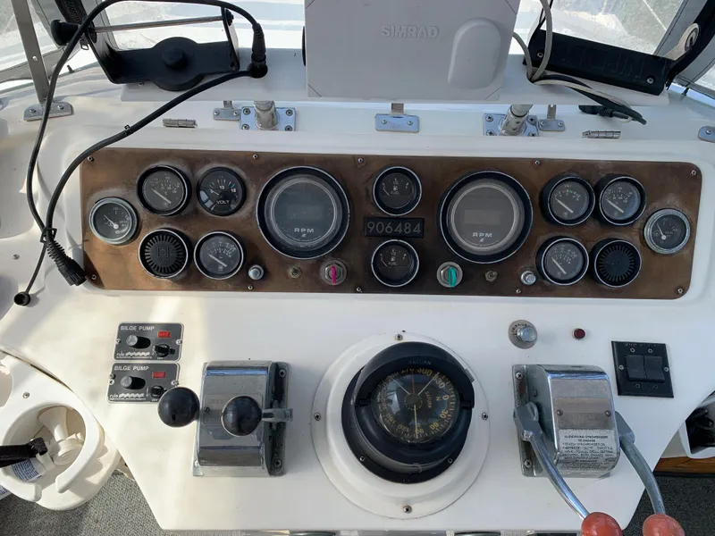 Slide: The Image of 1987 Kha Shing Vista 40 boat dashboard with gauges, controls, and compass. - 4