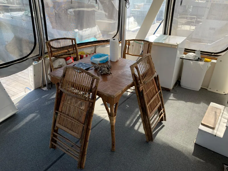 Slide: The Image of 1987 Kha Shing Vista 40 yacht interior with wicker table and chairs. - 5