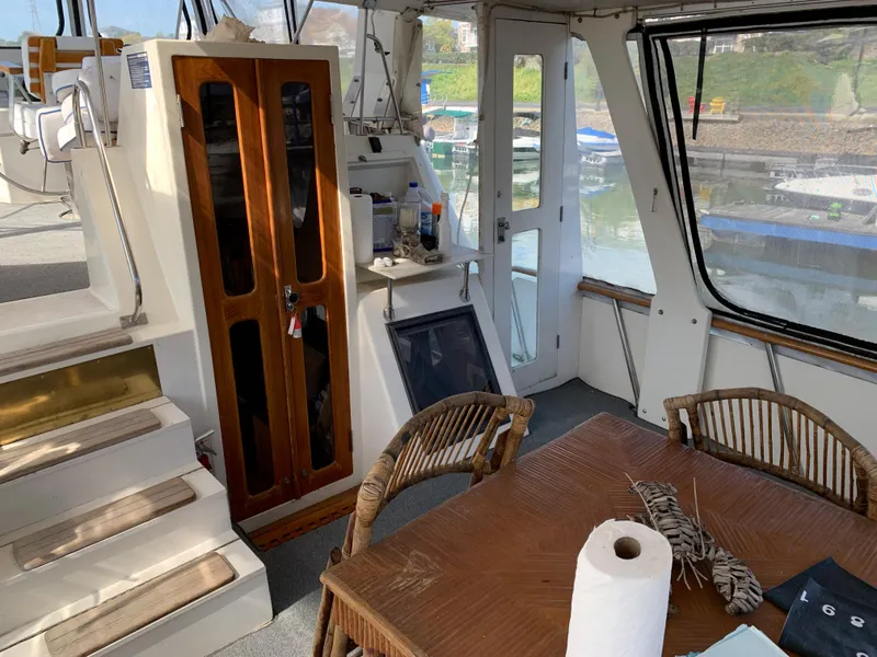 Slide: The Image of Interior of 1987 Kha Shing Vista 40 yacht with dining area and helm station. - 6