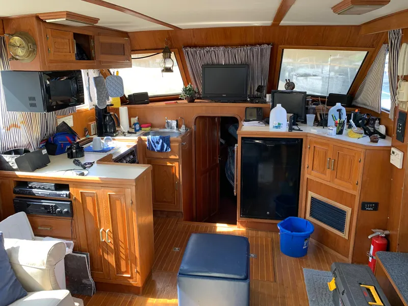 Slide: The Image of Interior of 1987 Kha Shing Vista 40 yacht with wooden cabinetry and modern amenities. - 8