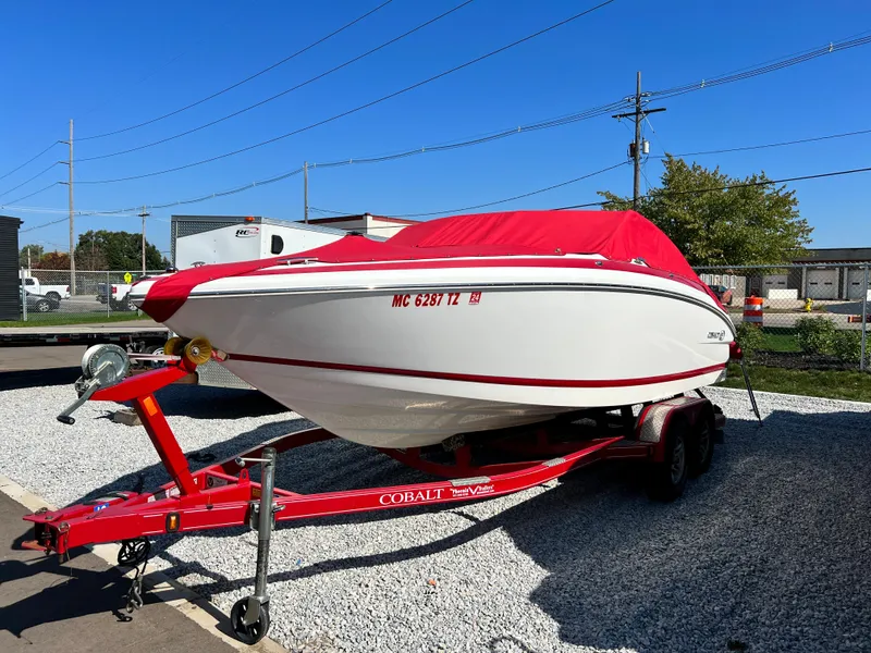 Slide: The Image of 2009 Cobalt 222 boat with red cover on a matching red trailer. - 0
