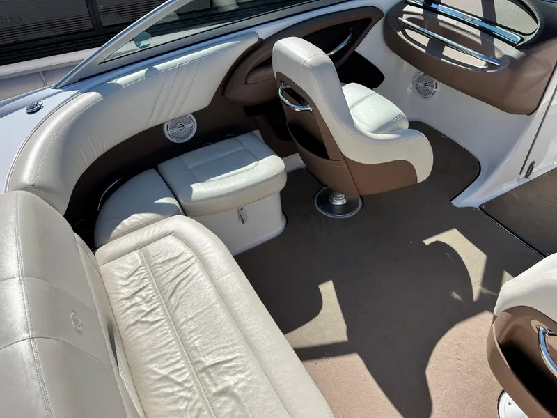 Slide: The Image of Interior of a 2009 Cobalt 222 boat with white and brown seating. - 15