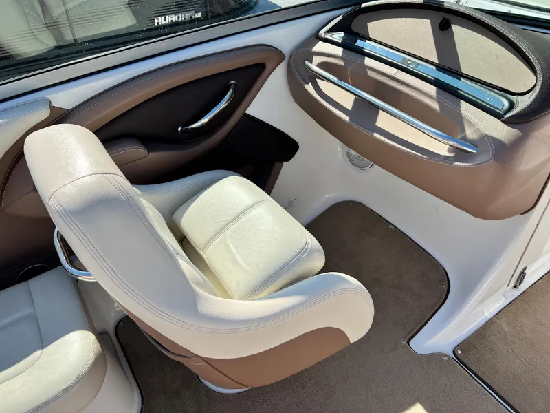 Slide: The Image of Interior of a 2009 Cobalt 222 boat with beige and brown seating. - 16