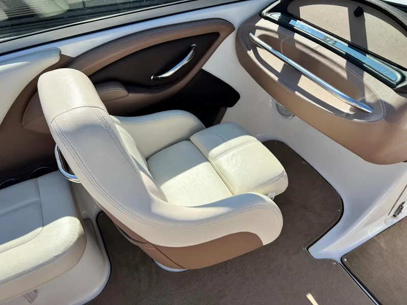 Slide: The Image of 2009 Cobalt 222 boat interior with beige and brown leather seats. - 17