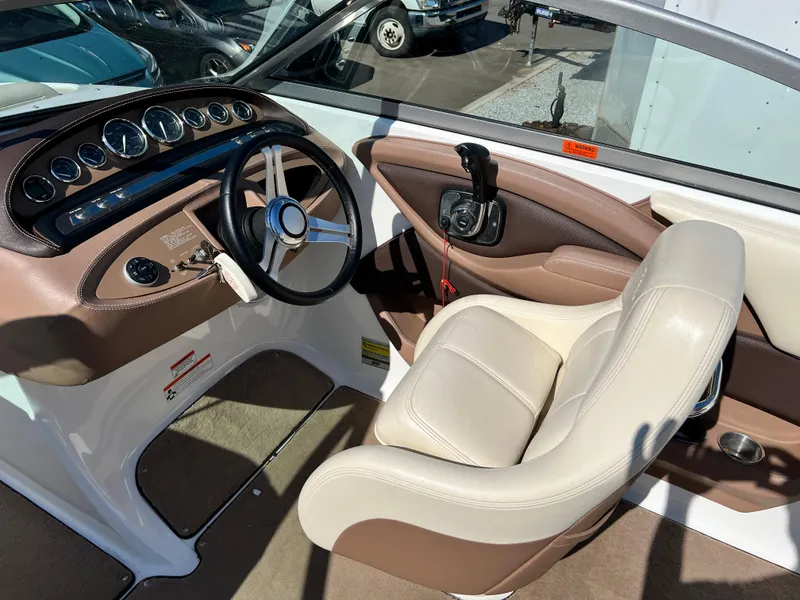 Slide: The Image of 2009 Cobalt 222 boat cockpit with steering wheel and captain's chair. - 18