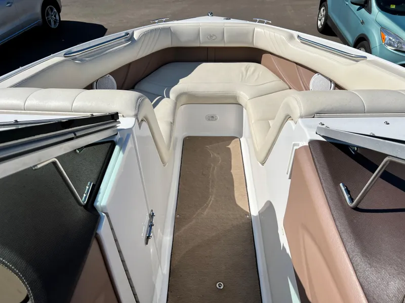 Slide: The Image of 2009 Cobalt 222 boat interior with beige and brown seating. - 19