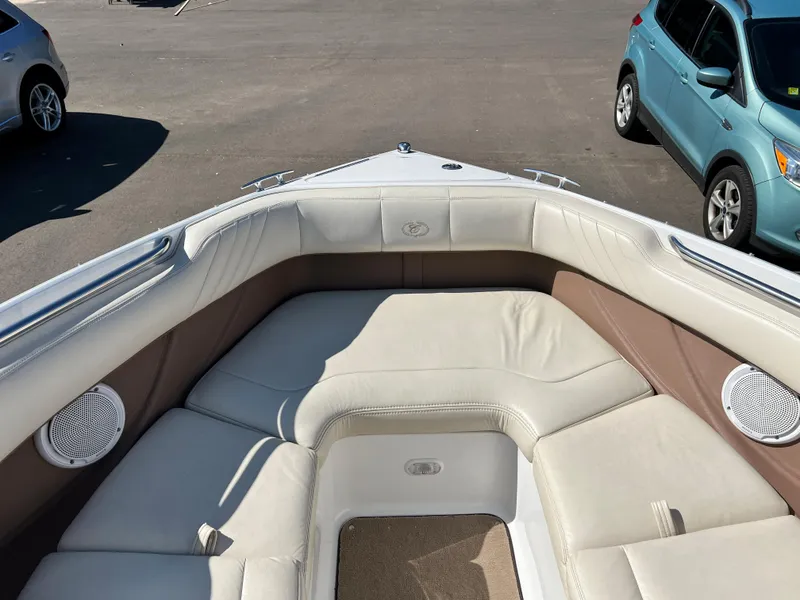 Slide: The Image of 2009 Cobalt 222 boat with beige leather seating and speakers in the bow area. - 21