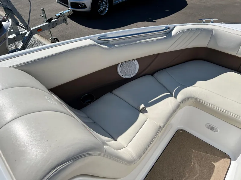 Slide: The Image of 2009 Cobalt 222 boat interior with white leather seating and speaker. - 22