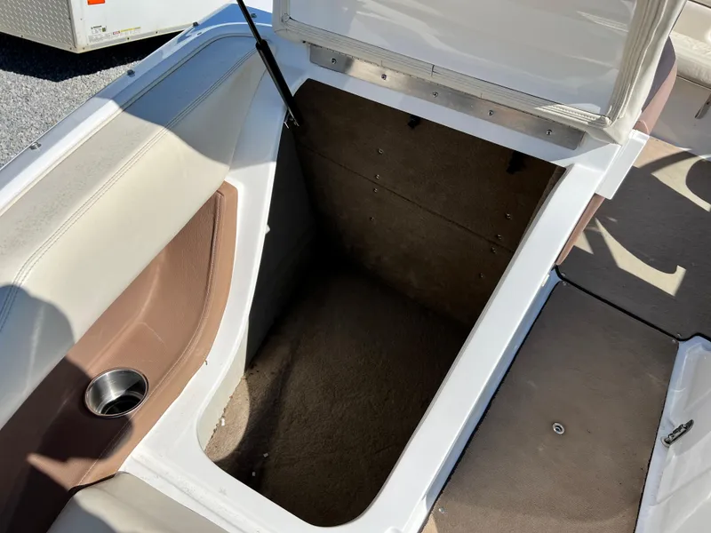 Slide: The Image of Open storage compartment on a 2009 Cobalt 222 boat. - 24