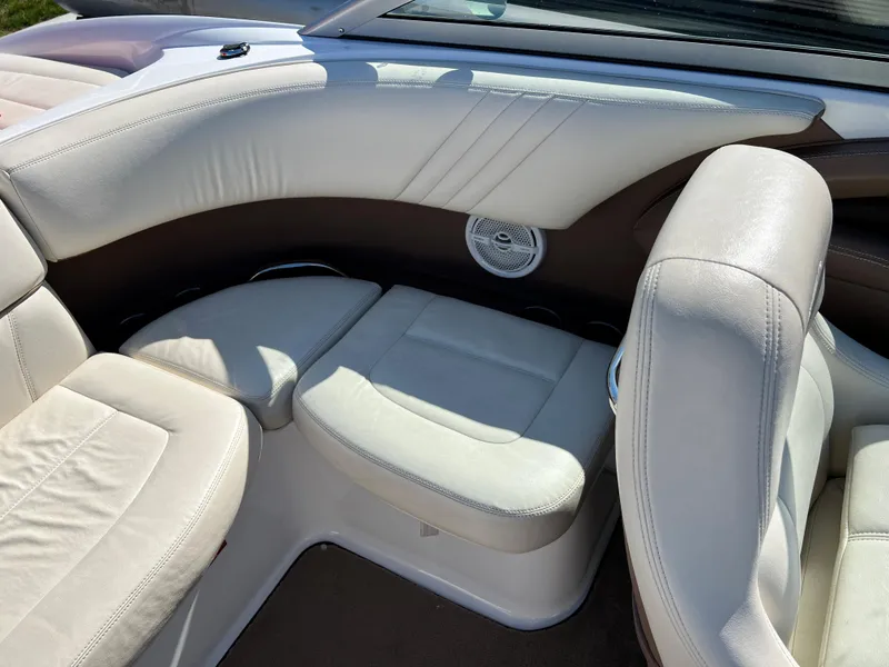 Slide: The Image of Interior seating of a 2009 Cobalt 222 boat with white upholstery. - 27