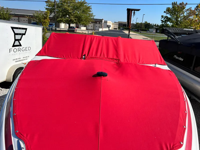 Slide: The Image of 2009 Cobalt 222 boat with red cover in outdoor storage. - 3