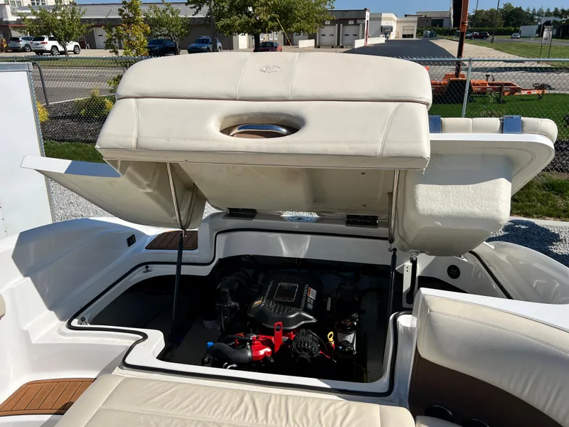 Slide: The Image of 2009 Cobalt 222 boat with open engine compartment in a marina. - 35