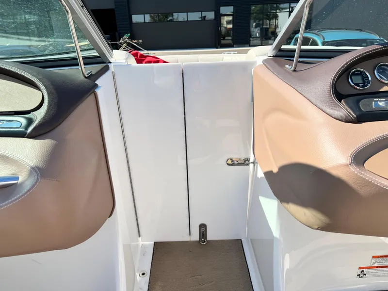 Slide: The Image of Interior view of a 2009 Cobalt 222 boat with tan and white seating. - 37