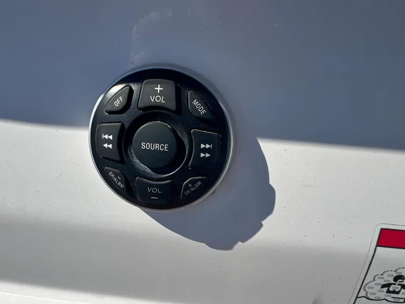Slide: The Image of 2009 Cobalt 222 boat audio control panel with volume and source buttons. - 38