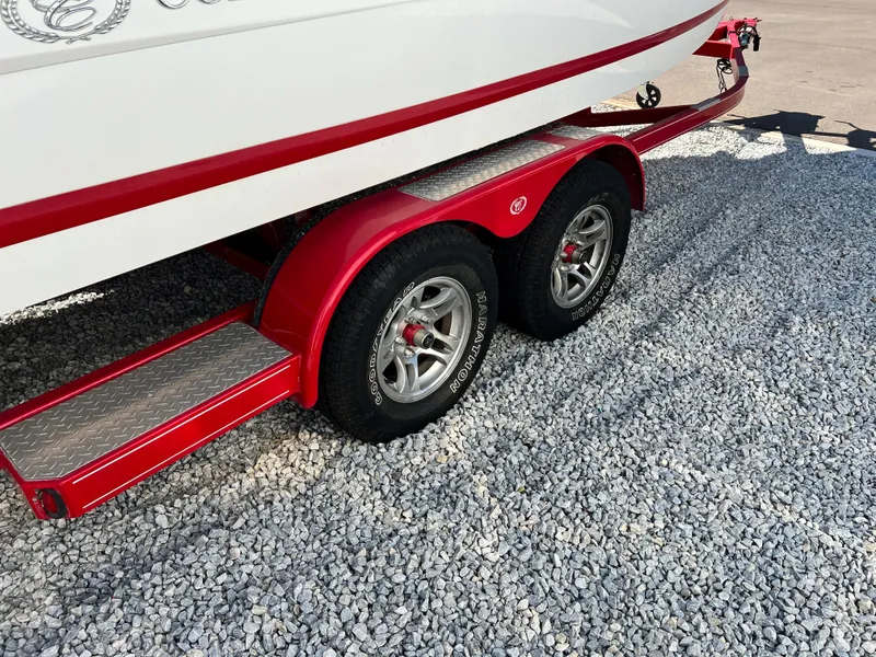 Slide: The Image of 2009 Cobalt 222 boat on a red dual-axle trailer with chrome wheels. - 5