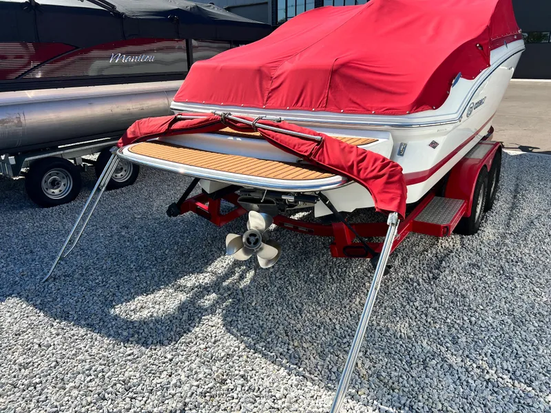 Slide: The Image of 2009 Cobalt 222 boat with red cover on trailer, rear view. - 6