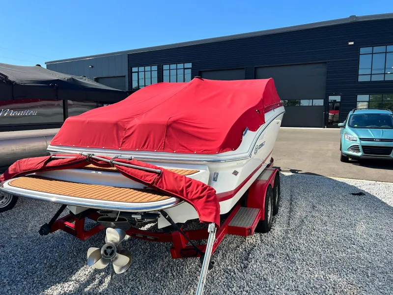 Slide: The Image of 2009 Cobalt 222 boat with red cover on trailer in parking lot. - 7