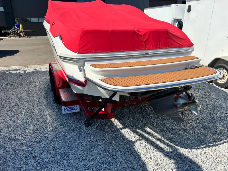 Slide: The Image of 2009 Cobalt 222 boat with red cover on trailer, rear view. - 8