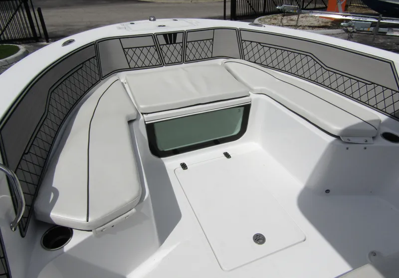 Slide: The Image of 2024 Wellcraft 202 Fisherman boat interior with cushioned seating and storage. - 10