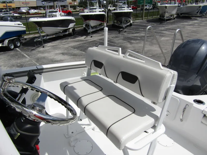 Slide: The Image of 2024 Wellcraft 202 Fisherman boat interior with steering wheel and seating. - 14