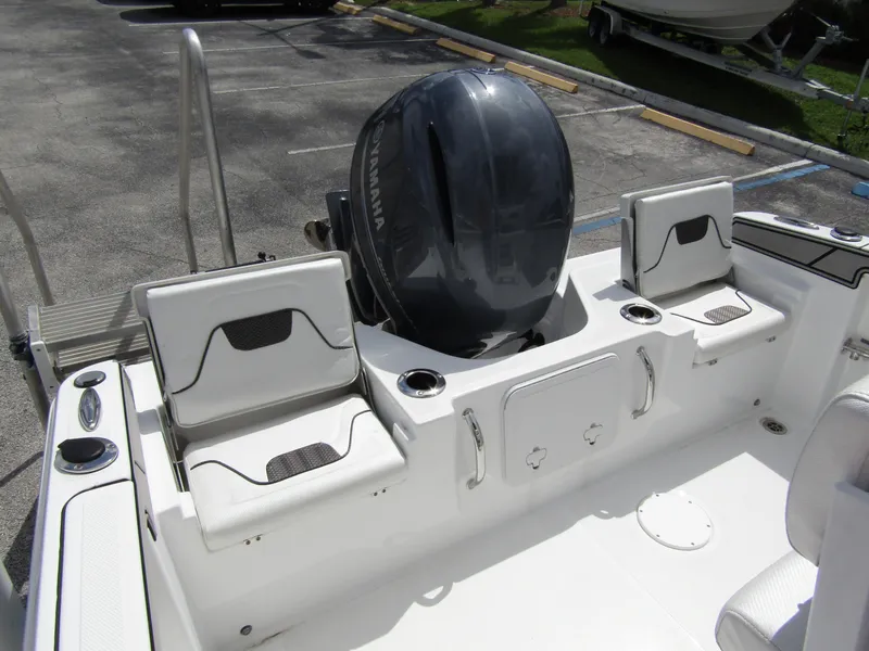 Slide: The Image of 2024 Wellcraft 202 Fisherman boat interior with Yamaha outboard motor and seating. - 24